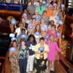 A group of people posing for a picture on a Galveston cruise ship.