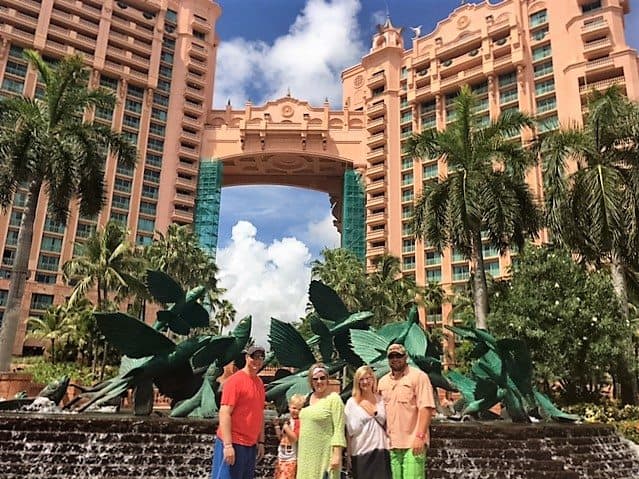 A group of people standing in front of a fountain at the Atlantis resort on a Royal Caribbean cruise aboard the Allure of the Seas.