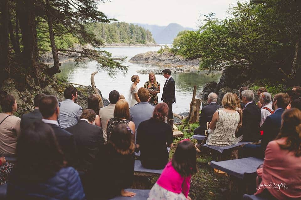 A wedding destination with a view of the ocean in a wooded area.