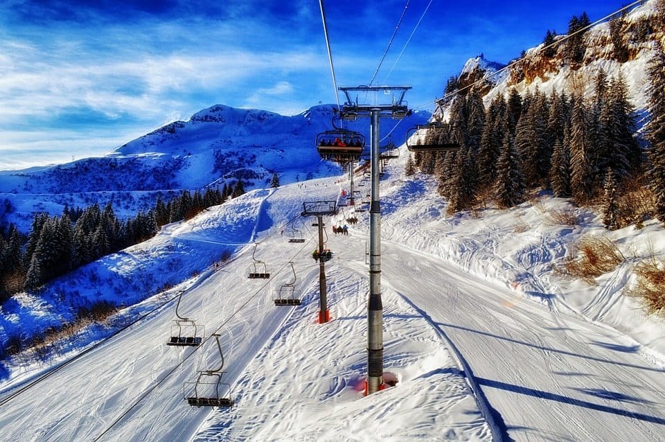 A ski lift at a ski resort on a snowy slope.
