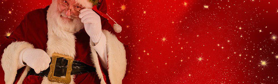 A festive Christmas website featuring Santa Claus against a vibrant red background.