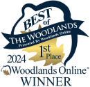 The image showcases a logo with a well-designed layout, featuring a blue eagle and a gold banner that reads: "The Woodlands, Presented by Woodlands Online, 1st Place". Below the header, it states "2022 Community Choice Award Winner".