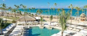 Excellence Resort Punta Cana offers an aerial view of a pool and palm trees.