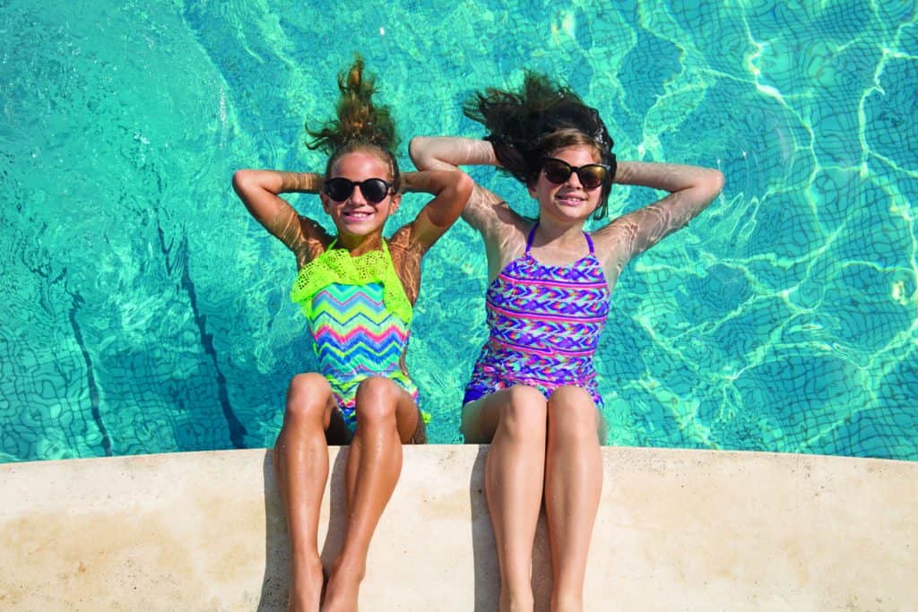 Two girls enjoying a pool at Nickelodeon Resort in their swimsuits.