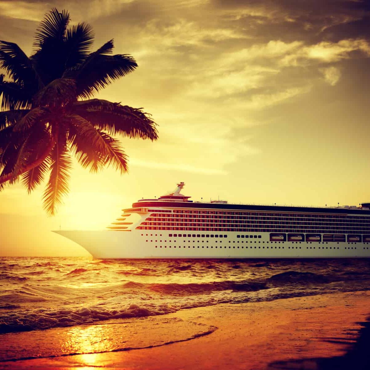 A beachfront cruise ship at sunset offering incredible cruise deals.