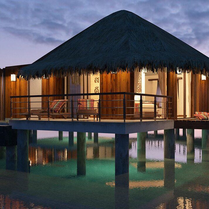 Two huts on stilts in the water at Secrets Maroma Beach.