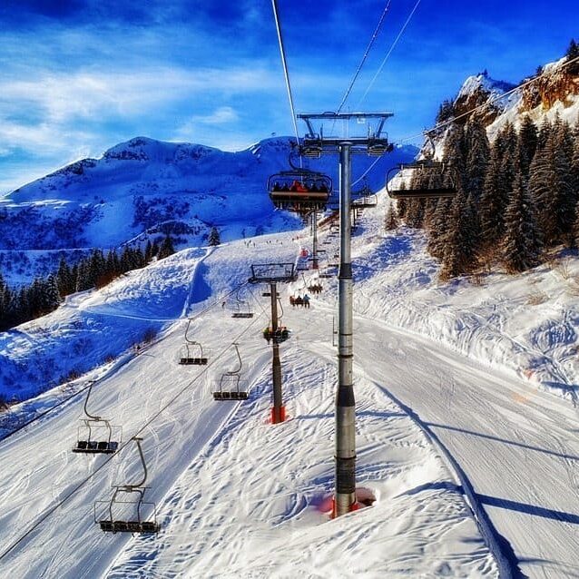 A ski lift at a ski resort on a snowy slope.